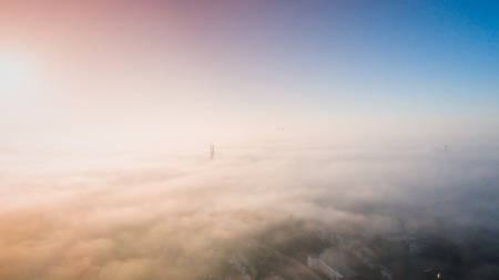 The city is covered with thick fog and protruding from it where neither where high-rise buildingsの写真素材