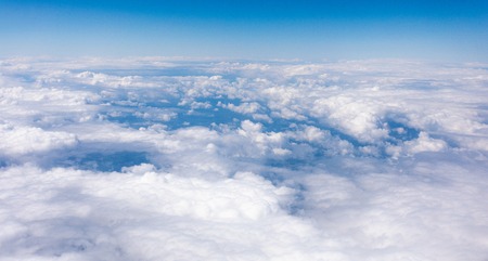 Earth in the airplane window with clouds