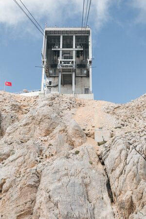 View of the upper station of the cableway to the Tahtali mountain in Kemer from the cab that goes...
