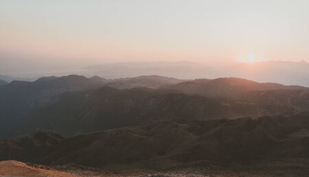 Beautiful mountain landscape with sunset over Taurus Mountains from the top of Tahtali Mountain near Kemer, Antalya, Turkey. Photo in orange and blue natural tones.の写真素材