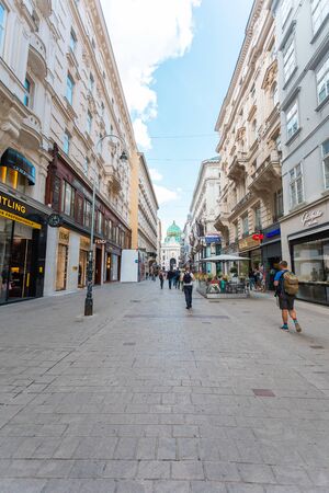 Colmarkt pedestrian street in the center of Vienna with many boutiques of famous brands and Hofburg in the background, Vienna, Austriaのeditorial素材