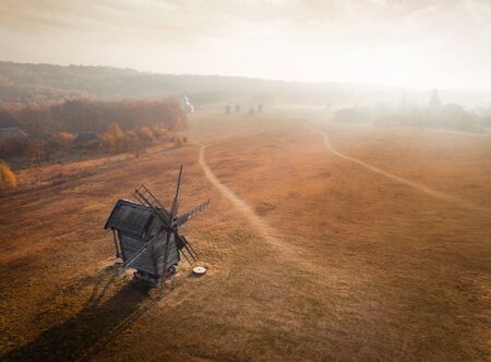 Panoramic aerial view of the National Museum of Folk Architecture and Life of Ukraine Pirogovo in the early autumn morning with fog and haze in the background. View of an ancient mill with fields in the background, Kyiv, Ukraineの写真素材