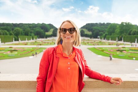 Young female tourist stands against a Schoenbrunn palace park in Vienna, Austriaのeditorial素材