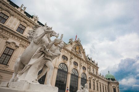 Facade of Schonbrunn Palace in Vienna with statues and a grand staircase in the foreground, Vienna, Austriaのeditorial素材