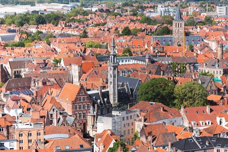 Panoramic aerial view of the old city of Bruges with towers and bright orange roofs, Belgiumの写真素材