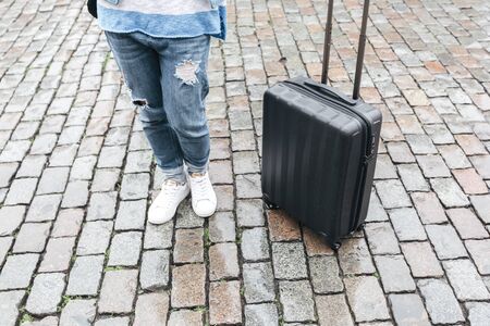 Woman tourist goes with a suitcase at the Grand Place in Brussels, Belgiumの写真素材
