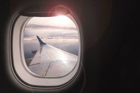 Airplane wing with beautiful sky from airplane windowの写真素材