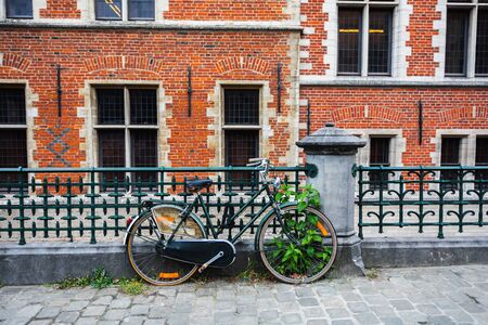 Old bicycle parked in front of a rustic cottageの写真素材