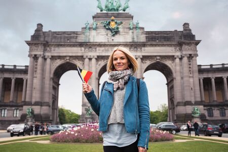 Young woman with Triumphal Arch in Cinquantennaire Park in Brussels, Belgiumの写真素材