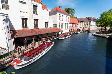 Cityscape of Bruges overlooking the canal and boats for excursions.の写真素材