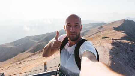 Male tourist on a viewing platform of Tahtali Mountain in Turkey, Kemer, Antalyaの写真素材