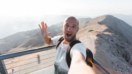 Male tourist on a viewing platform of Tahtali Mountain in Turkey, Kemer, Antalyaの写真素材