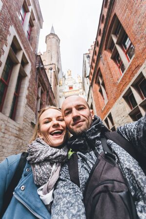 Young couple of City Hall of Bruges, Belgiumの写真素材