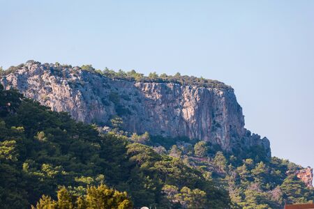 Mountain landscape with a protruding rock on a background of greeneryの写真素材