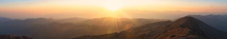 Panoramic view of the mountain landscape during twilight at sunset. Mountain silhouettes. View from Mount Tahtali near Kemer to Taurus Mountains, Turkeyの写真素材