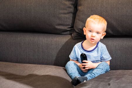 Little boy watching tvの写真素材