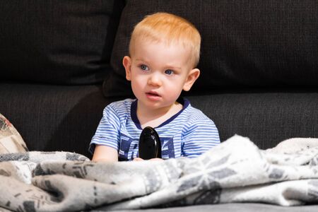 Little boy watching tvの写真素材