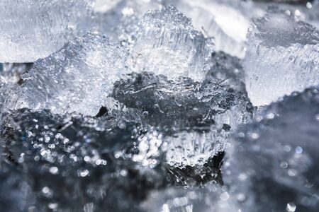 Abstract background with broken pieces of ice of natural origin on a dark background.の写真素材