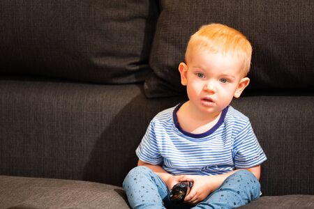 Little boy watching tvの写真素材