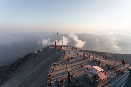 Kemer, Turkey - September 20, 2019: People enjoy stunning sunset on the observation deck of Tahtali...