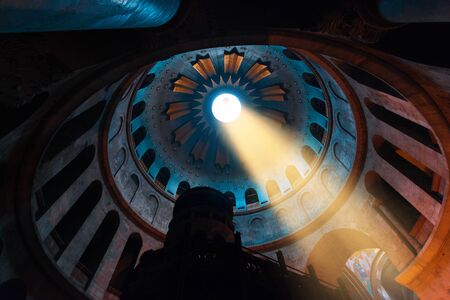 Interior of the Temple of the Holy Sepulcher in Jerusalem with a ray of sunshine through an opening in the dome, Israelの写真素材