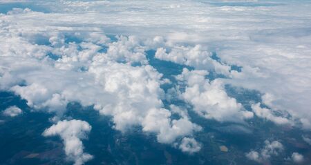 Sky with clouds from airplane window during flightの写真素材