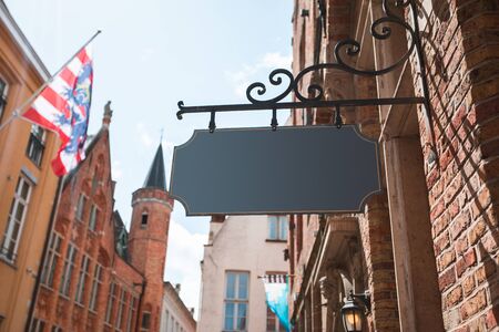 Hanging black sign of houses in the traditional Dutch style.の写真素材