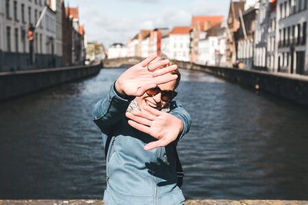 Woman tourist sitting and enjoying a center of Bruges, Belgiumの写真素材