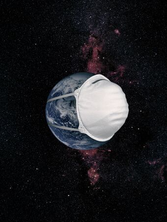 Concept Earth with a protective mask during a Covid-19 epidemic or coronavirus against the milky way.の写真素材