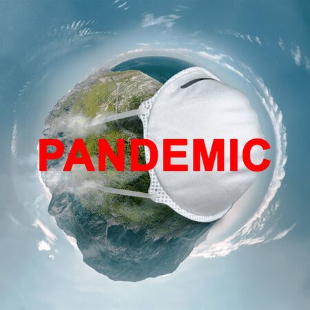Concept Earth with a protective mask during a Covid-19 epidemic or coronavirus with the inscription pandemic.の写真素材