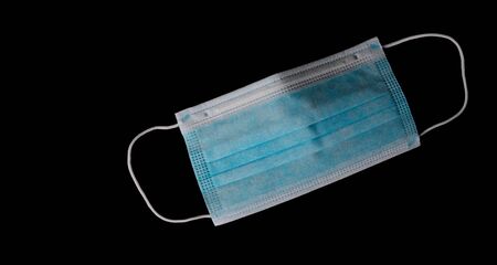 Medical mask isolated on blackの写真素材