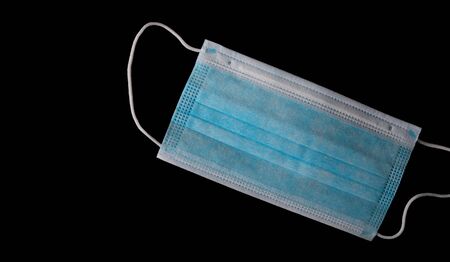 Medical mask isolated on blackの写真素材
