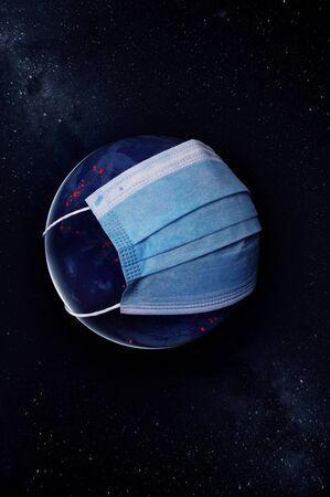 Concept Earth with a protective mask during a Covid-19 epidemic or coronavirus.の写真素材