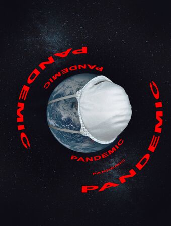 Planets Earth with a medical mask with the inscription pandemic around the globe on a  of the starry sky.の写真素材