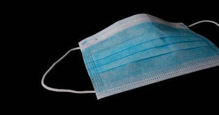 Medical mask isolated on blackの写真素材