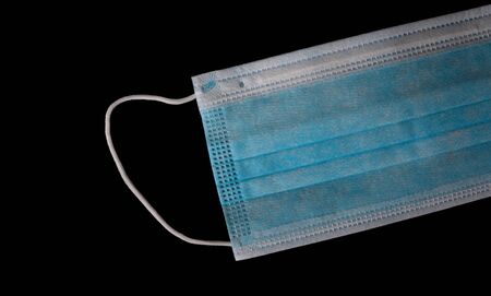 Medical mask isolated on blackの写真素材