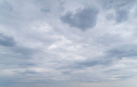 Cloudy gray sky with thick dense clouds.の写真素材