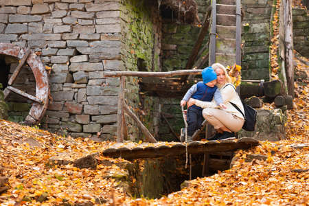 Happy woman with son walking in autumn parkの写真素材