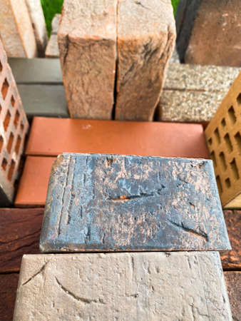 Different types of bricks stacked beautifully on green grassの写真素材