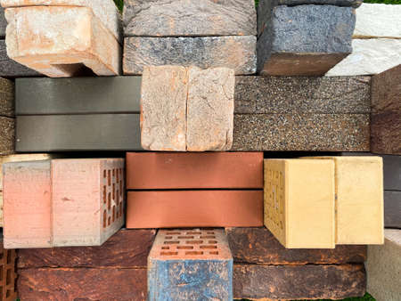 Different types of bricks stacked beautifully on green grassの写真素材
