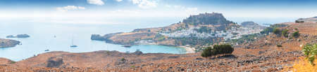 Panoramic view of the old town of Lindos in Greece with the acropolis on top of the hill.の写真素材
