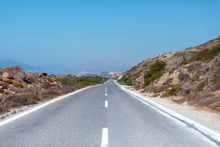 Asphalt road in a mountainous area, Rodos island, Greeceの写真素材