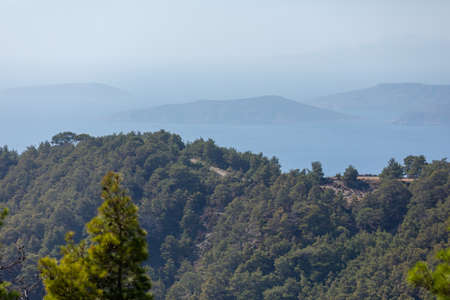 Seascape with multi-tiered backgrounds receding into the distance. Silhouettes of mountains in the seaの写真素材