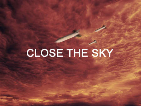 A projectile flies against the background of a scarlet red skyの写真素材