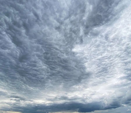 Dark blue cloudy sky with low cloudsの写真素材