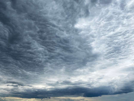 Dark blue cloudy sky with low cloudsの写真素材