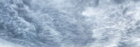 Dark blue cloudy sky with low cloudsの写真素材
