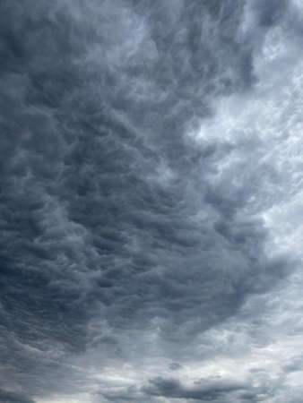 Dark blue cloudy sky with low cloudsの写真素材