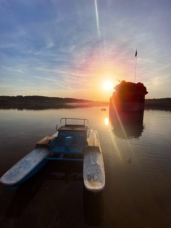 Beautiful landscape at sunset with a lake and a catamaranの写真素材