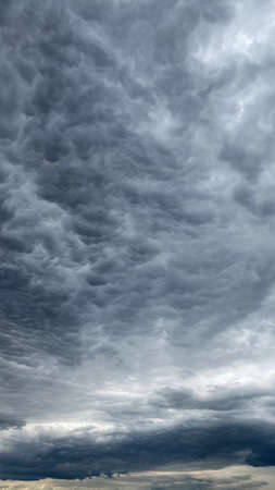 Dark blue cloudy sky with low clouds